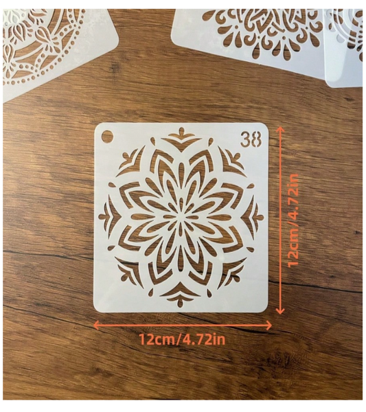 A square white stencil with a floral mandala pattern, shown on a wooden surface with orange dimension markings indicating 12cm/4.72in by 12cm/4.