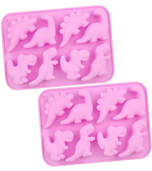 Two pink silicone baking molds with dinosaur-shaped cavities, displayed on a clean white background.