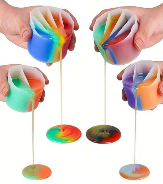 Translucent silicone cups with layered rainbow-colored material, pouring thin liquid into round discs below on a white background.