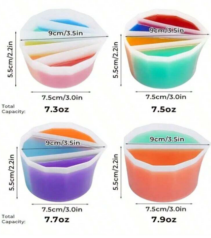 Four small translucent silicone measuring cups on a white background
