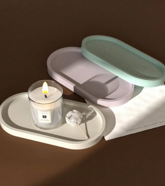 A set of minimalist pastel-colored oval trays in white, lavender, and mint green.