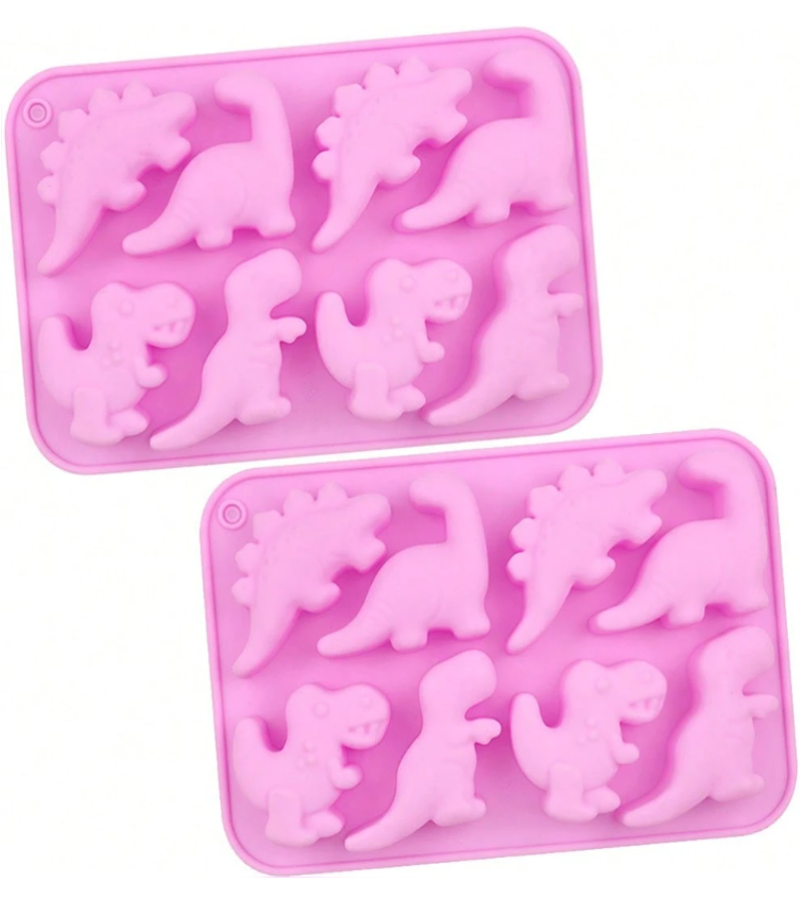 Two pink silicone baking molds with dinosaur-shaped cavities, displayed on a clean white background.